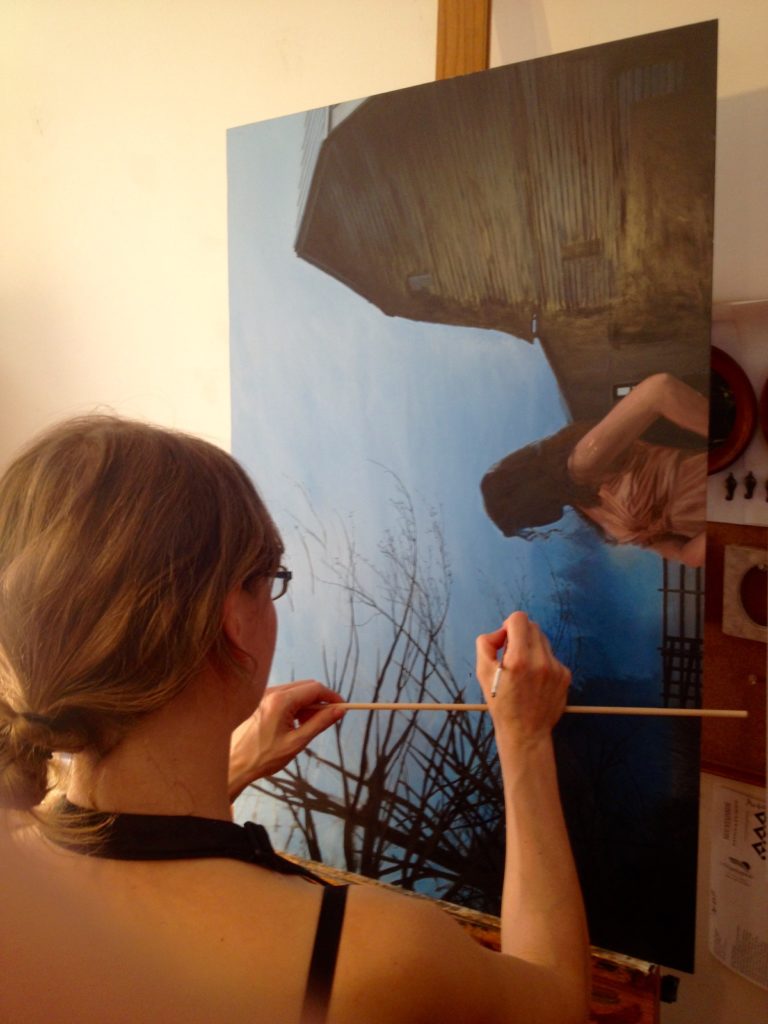 artist Rebecca Luncan working in the studio on figurative oil painting