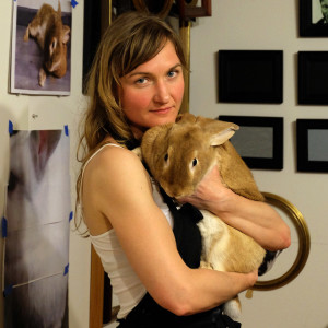 Seattle portrait artist Rebecca Luncan with her rabbit and muse in the painting studio